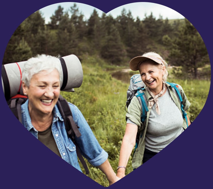 Two adults hike wearing backpacks