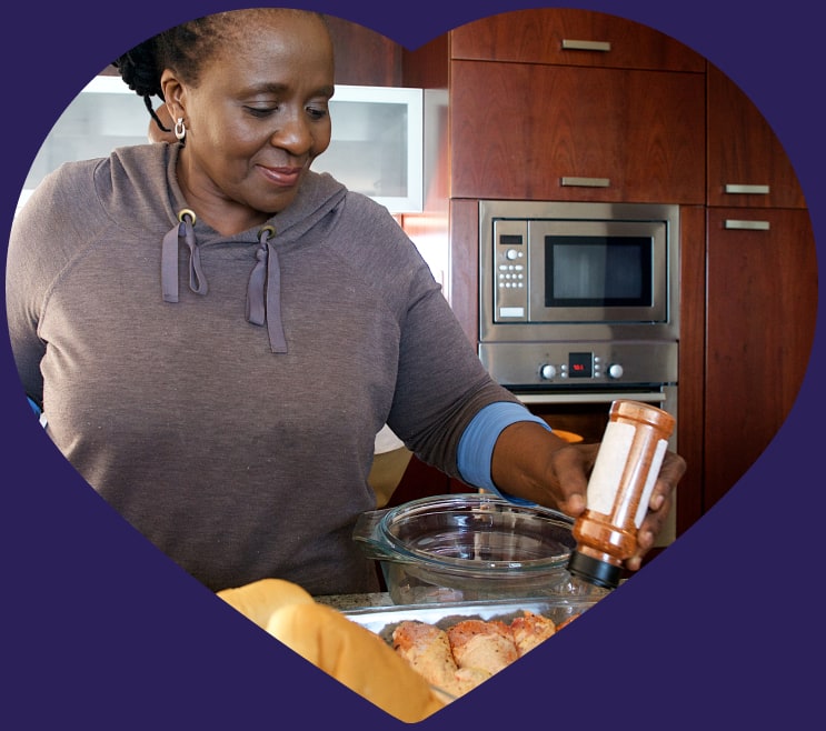 Woman seasoning chicken